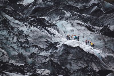 People skiing on snow covered mountains