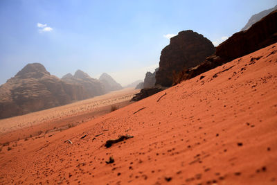 Surface level of desert against sky