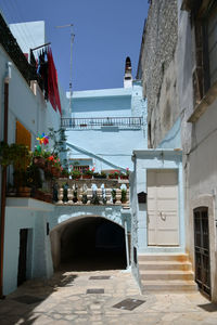 A small street in casamassima, a village with blue-colored houses in the puglia region of italy.