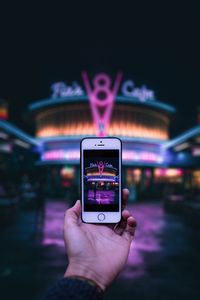 Midsection of person using smart phone at night