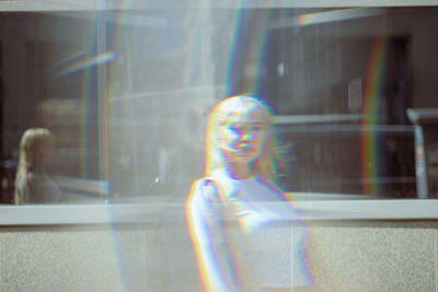 Double exposure of beautiful young woman standing in front of building