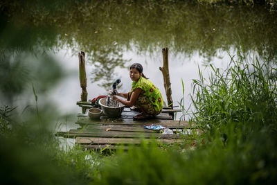 Man sitting on boat in lake