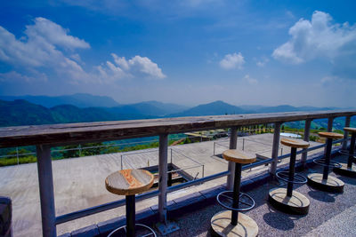 Chairs and tables against blue sky