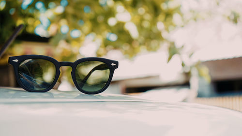 Close-up of sunglasses on glass table