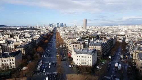 High angle view of city buildings against cloudy sky