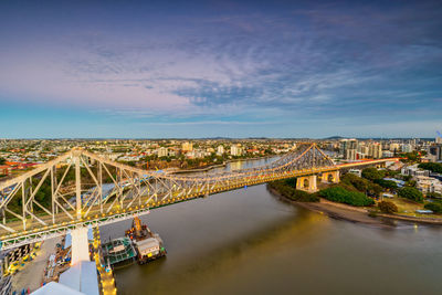 High angle view of river amidst buildings in city against sky