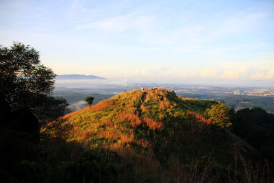 Scenic view of field and mountains against sky