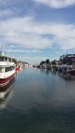 View of harbor against cloudy sky