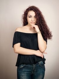 Portrait of beautiful woman against white background