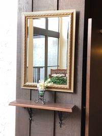 Potted plant against window of building