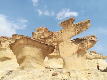 Low angle view of rock formation against sky