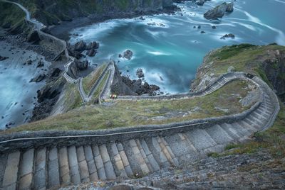 High angle view of staircase on mountain by sea