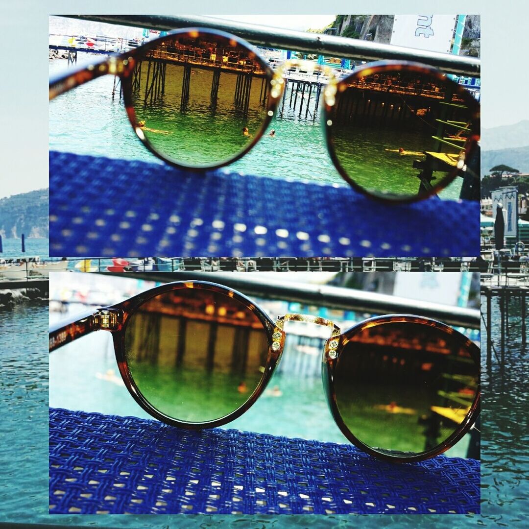 reflection, sunglasses, close-up, transportation, mode of transport, multi colored, circle, day, glass - material, no people, water, outdoors, blue, part of, swimming pool, sunlight, building exterior, architecture, built structure, amusement park