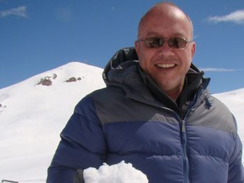 Portrait of smiling man in snow against sky