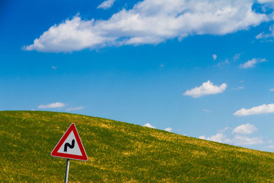 Road sign against sky