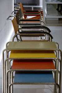 Close-up of empty chairs at table