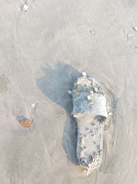 High angle view of footprints on sand at beach