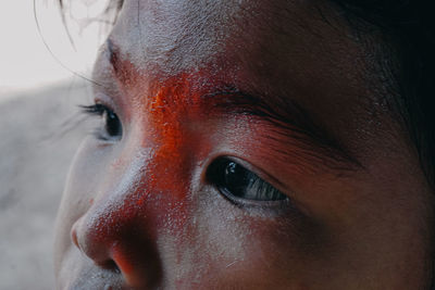 Close-up of young woman with wet face looking away