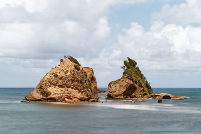 Panoramic view of rocks on beach against sky