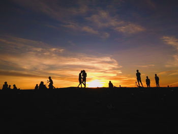 Silhouette people against sky during sunset