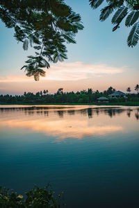 Scenic view of lake against sky at sunset