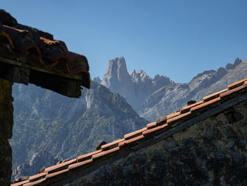 Low angle view of snowcapped mountains against clear sky