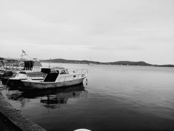 Boats moored in sea against sky