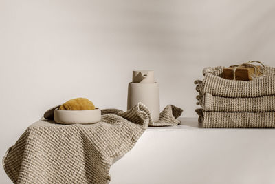 Close-up of coffee cup on table against wall at home