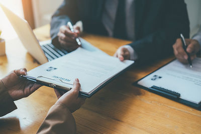 High angle view of man using mobile phone on table