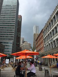 Buildings against cloudy sky