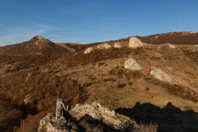 Scenic view of mountain range against blue sky