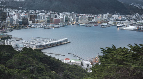 High angle view of buildings by sea in city