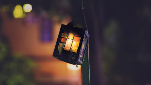 Close-up of lit lantern against blurred background