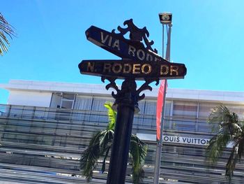 Low angle view of road sign against clear sky