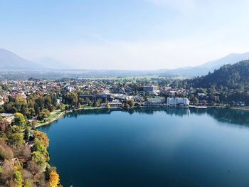 Scenic view of lake by buildings against sky