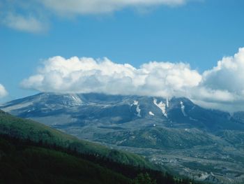 Scenic view of mountains against cloudy sky