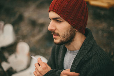 Close-up of young man smoking cigarette