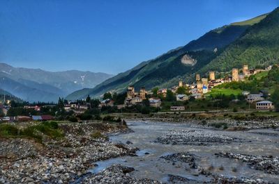 Town by mountain against sky