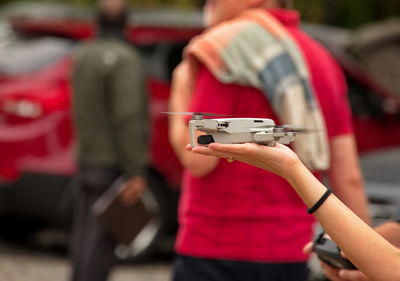 Midsection of man holding camera