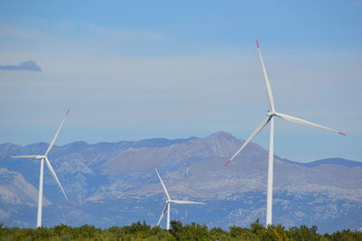 Windmill on mountain against sky