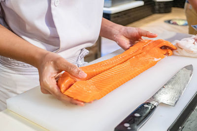 Midsection of man preparing food in kitchen