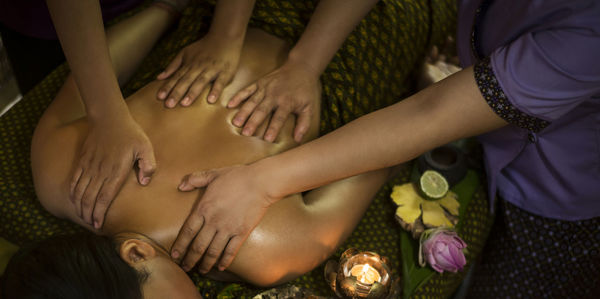 Midsection of woman getting herbal message at spa