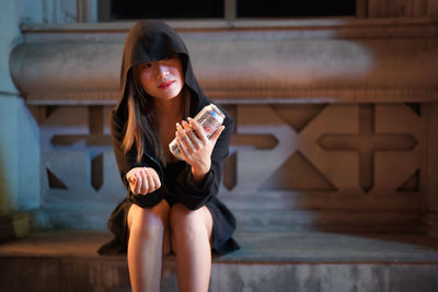 Portrait of young woman using mobile phone