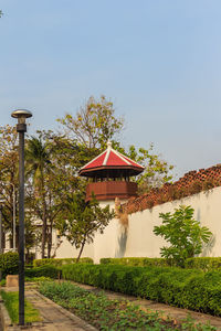 Built structure by trees against sky