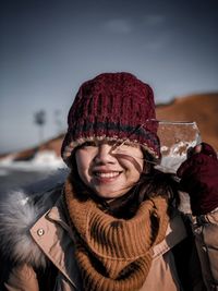 Portrait of smiling woman holding ice