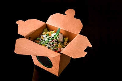 High angle view of gift box against black background