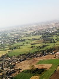 Scenic view of grassy field against sky