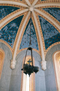 Low angle view of illuminated chandelier in building