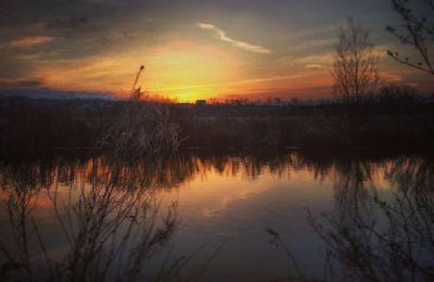 Scenic view of lake at sunset