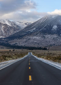 Highway leading to snow covered mountains